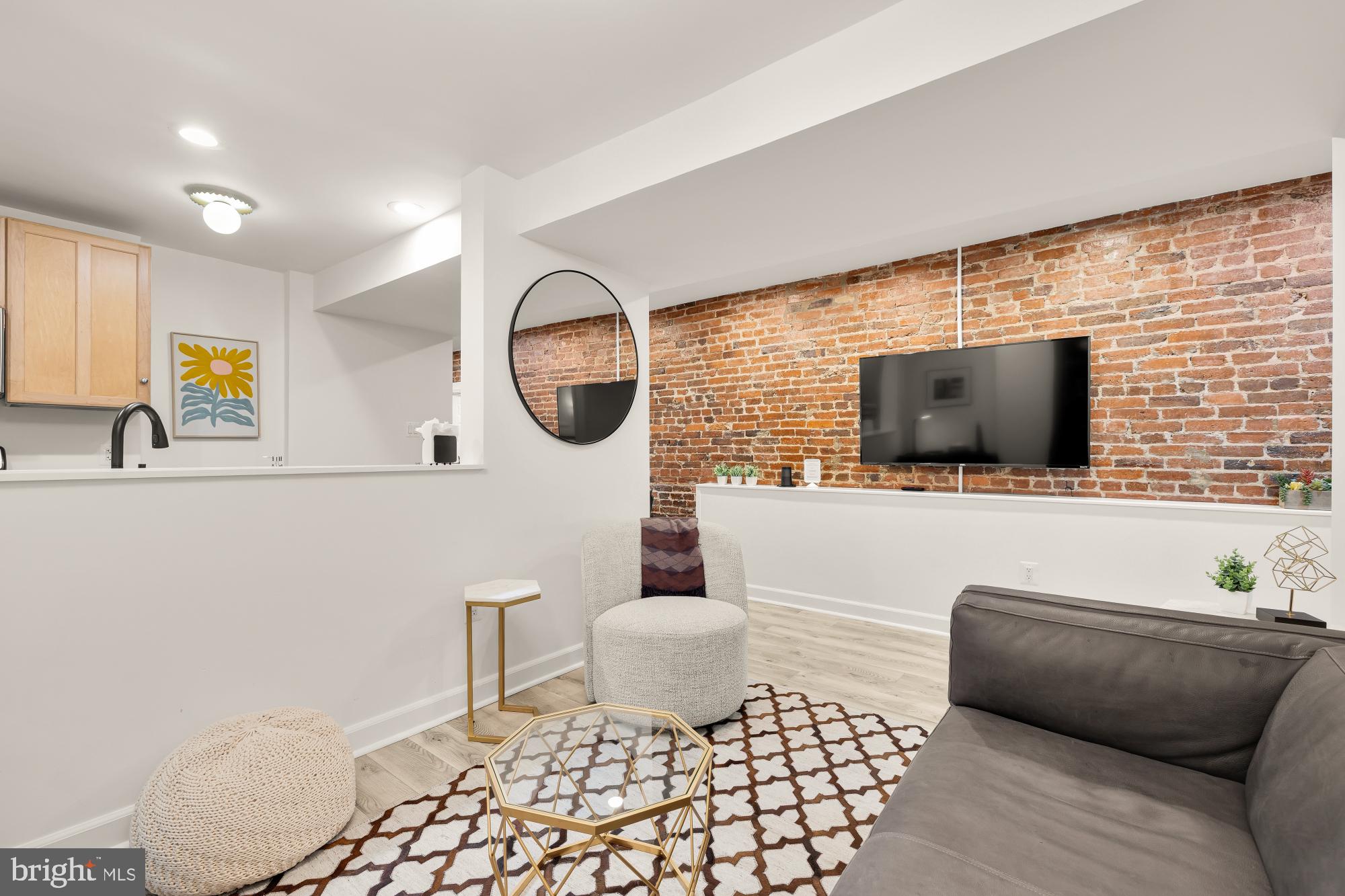 1214 T Street Northwest Washington, DC 20009 - Photo 62 of 88 a living room with a couch and a flat screen tv
