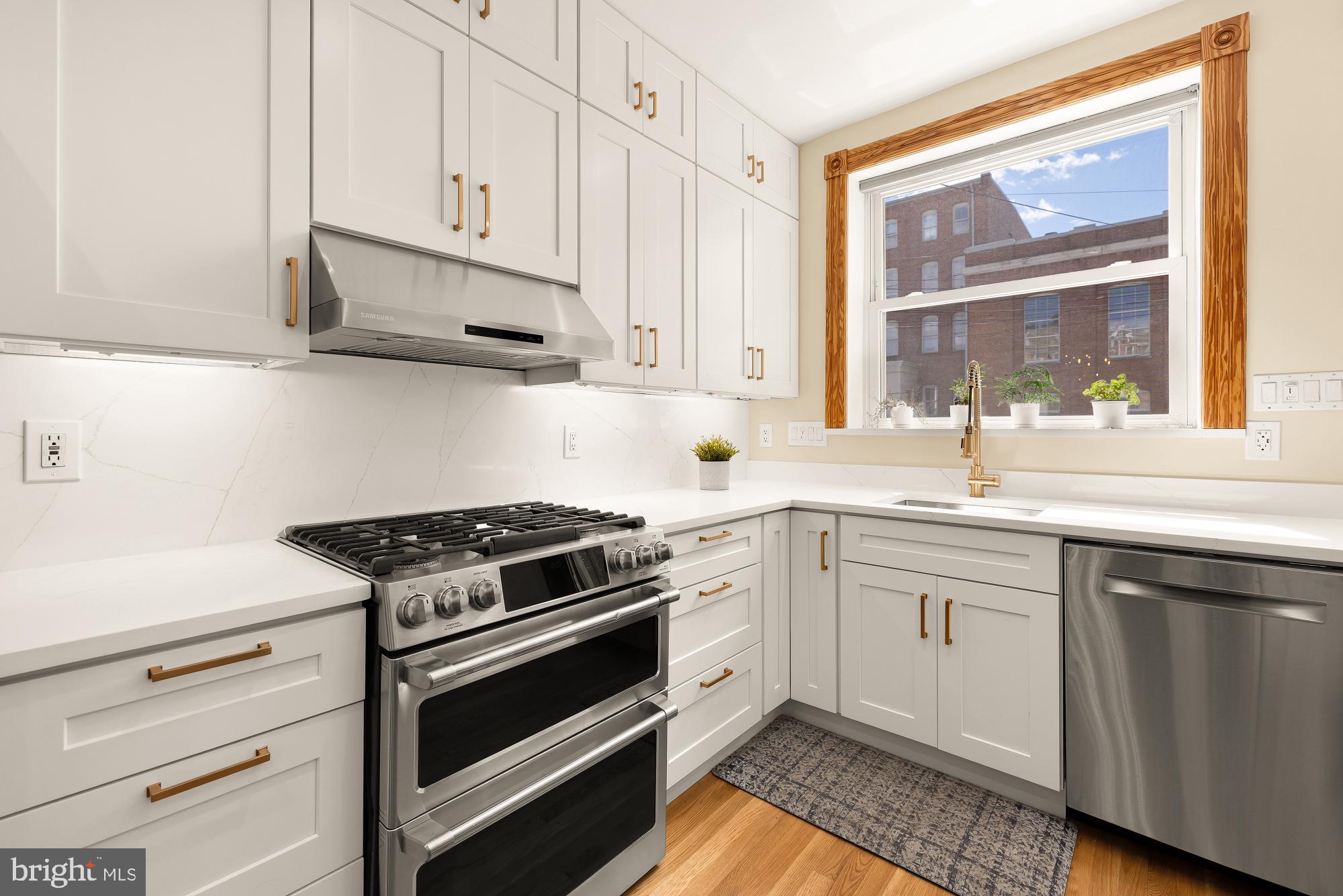 1214 T Street Northwest Washington, DC 20009 - Photo 7 of 88 a kitchen with granite countertop white cabinets and a stove top oven