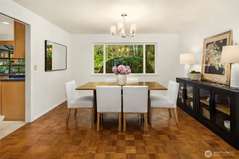 a dining room with furniture a chandelier and window