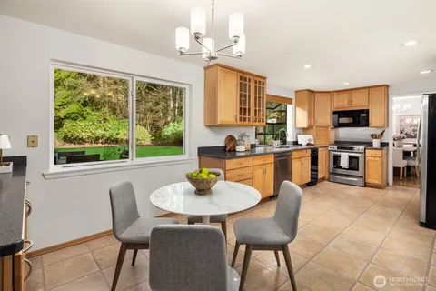 a dining room with furniture a window and kitchen view