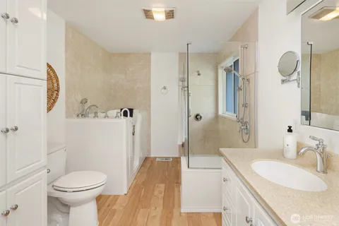 a bathroom with a sink toilet and shower