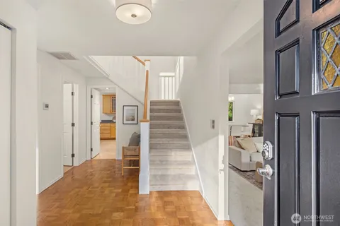 a view of entryway and hall with wooden floor