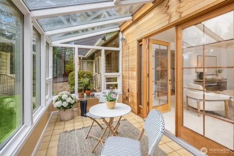 a balcony with table and chairs