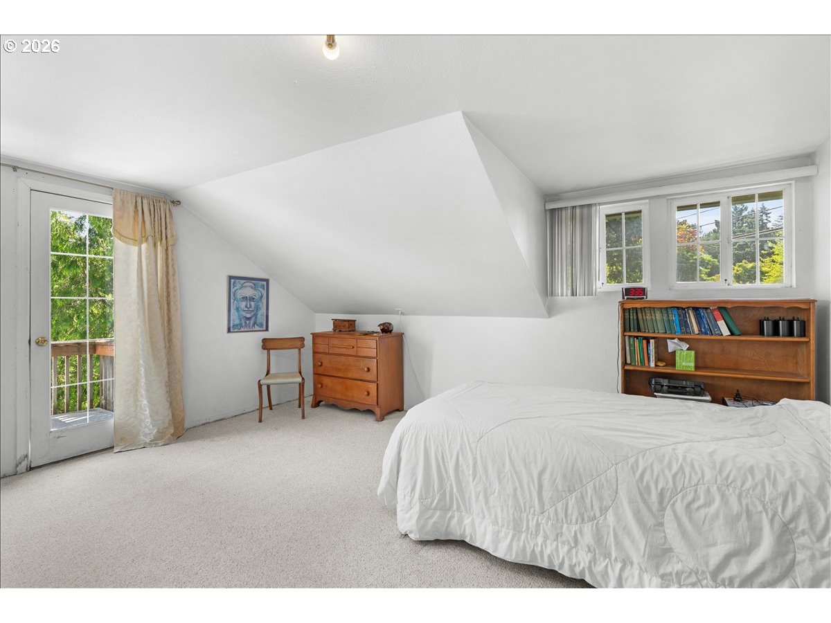 772 Division Street Oregon City, OR 97045 - Photo 13 of 47 a bedroom with a bed and a large window