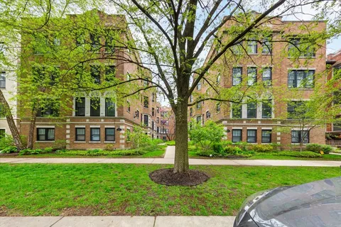 a front view of a residential apartment building with a yard