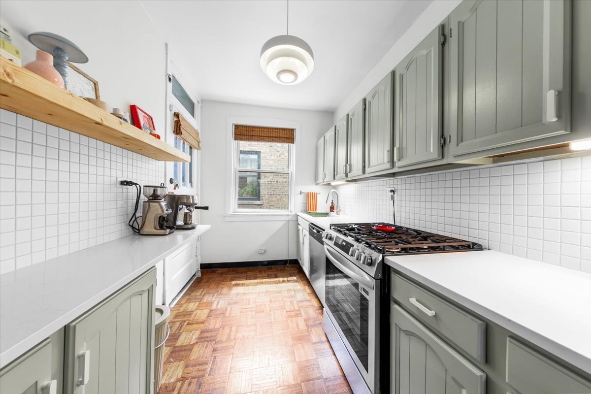 602 Sheridan Road, Unit 3E Evanston, IL 60202 - Photo 14 of 21 a kitchen with a stove a sink and a window