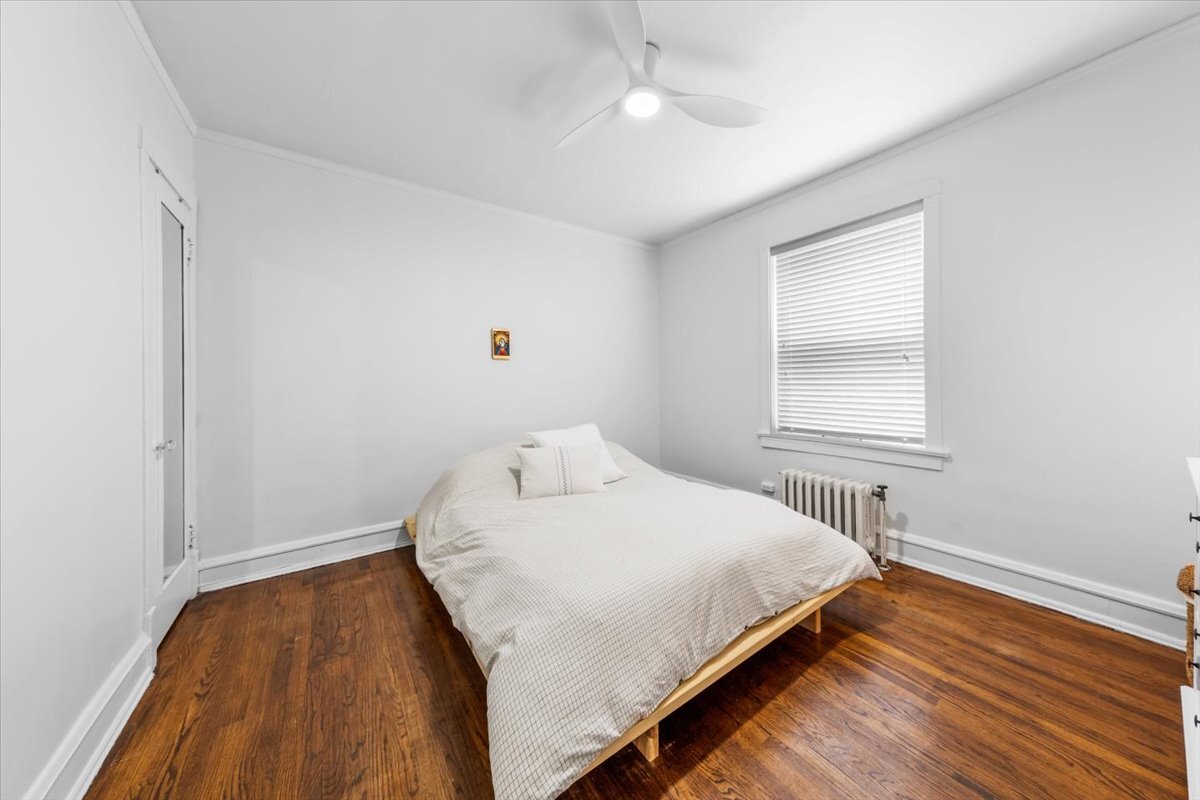 602 Sheridan Road, Unit 3E Evanston, IL 60202 - Photo 17 of 21 a bedroom with a bed and wooden floor