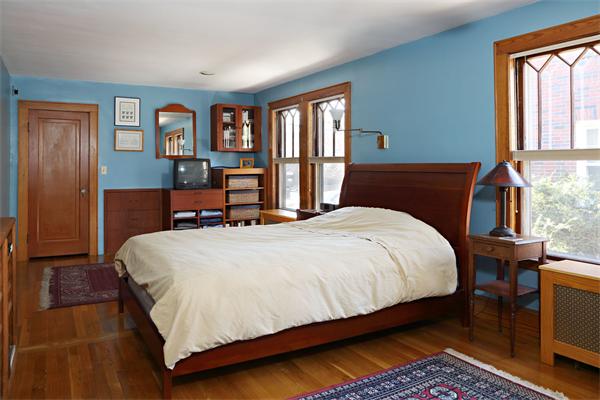 41 Pershing Road Boston, MA 02130 - Photo 5 of 8 a bedroom with a large bed and a window