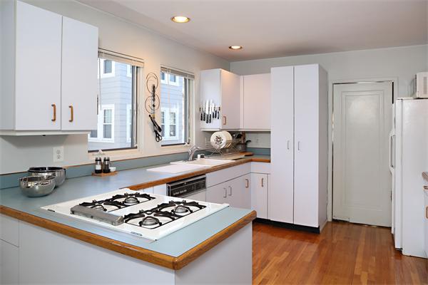 41 Pershing Road Boston, MA 02130 - Photo 7 of 8 a kitchen with stainless steel appliances a stove a sink and a refrigerator