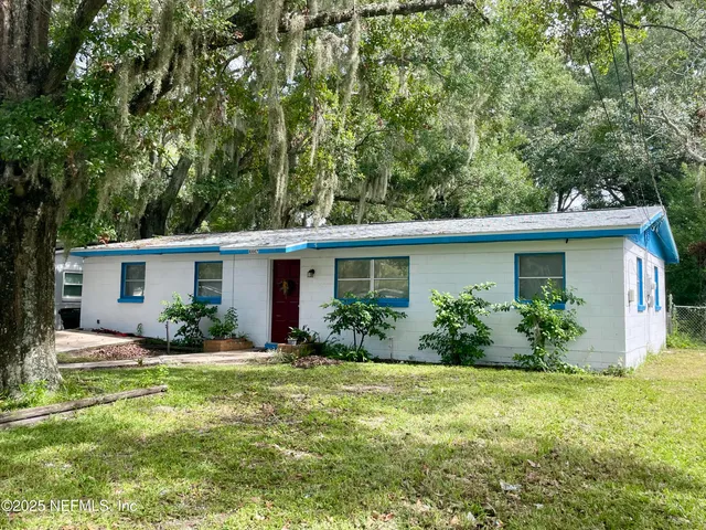 a front view of house with yard and green space