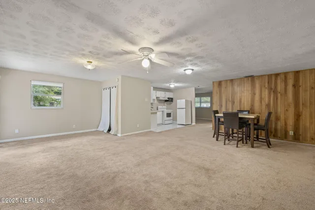 an empty room with furniture and a window