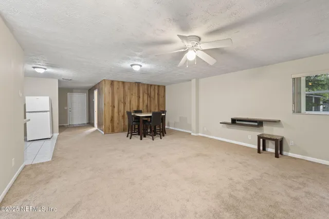 a view of workspace with furniture and a ceiling fan