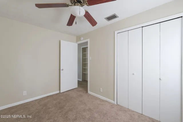 an empty room with ceiling fan