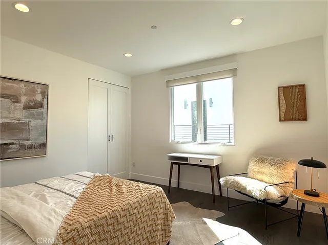 a bedroom with furniture and a window