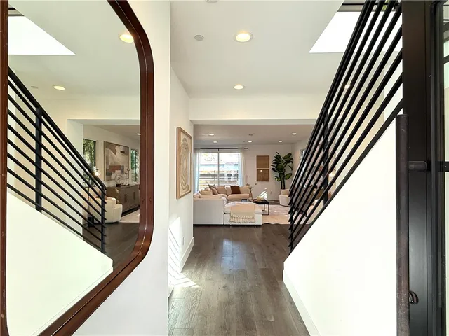 a view of a hallway with furniture and floor to ceiling window