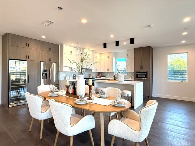 a dining room with furniture a window and wooden floor