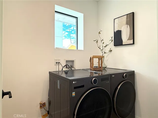 a view of bathroom with a washer and dryer