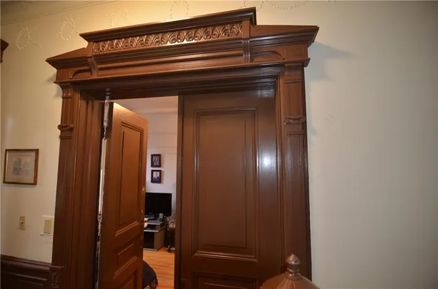 a view of a hallway with wooden floor