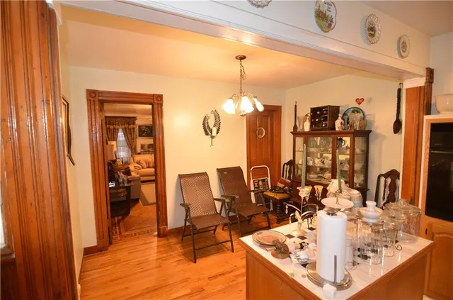 a living room with furniture a lamp wooden floor and a chandelier