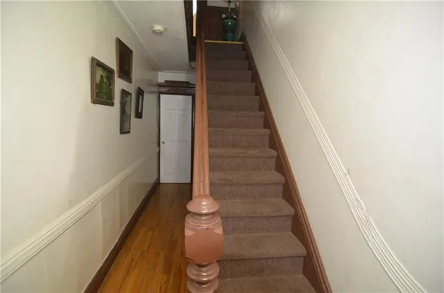 a view of entryway and hall with wooden floor