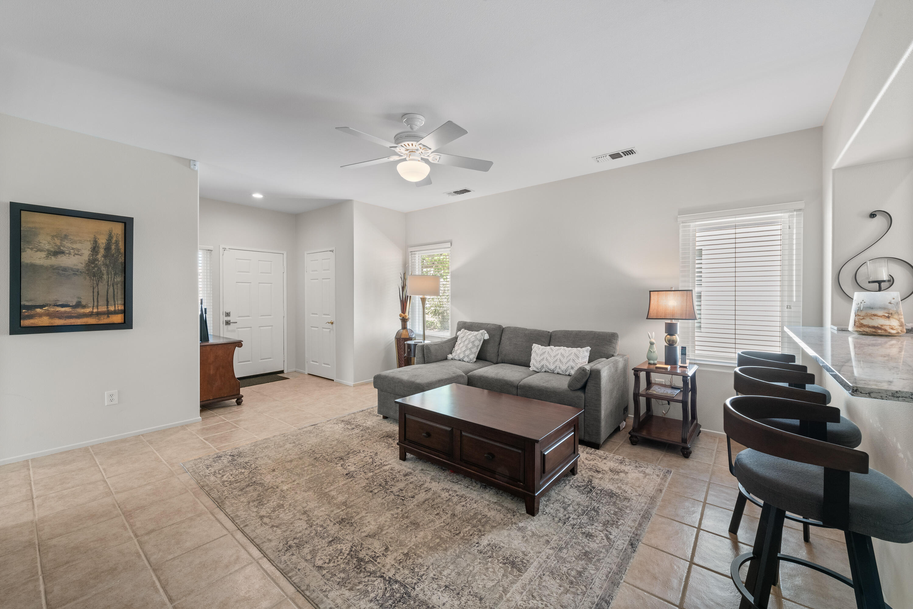 78680 Postbridge Circle Palm Desert, CA 92211 - Photo 11 of 54 a living room with furniture and a dining table