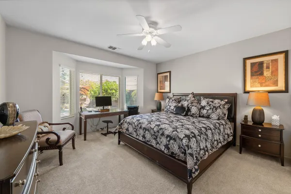 a bedroom with a bed and ceiling fan