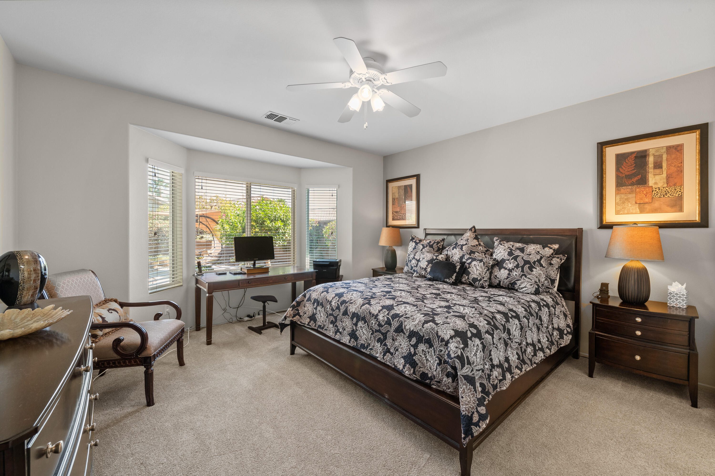 78680 Postbridge Circle Palm Desert, CA 92211 - Photo 15 of 54 a bedroom with a bed and a couch