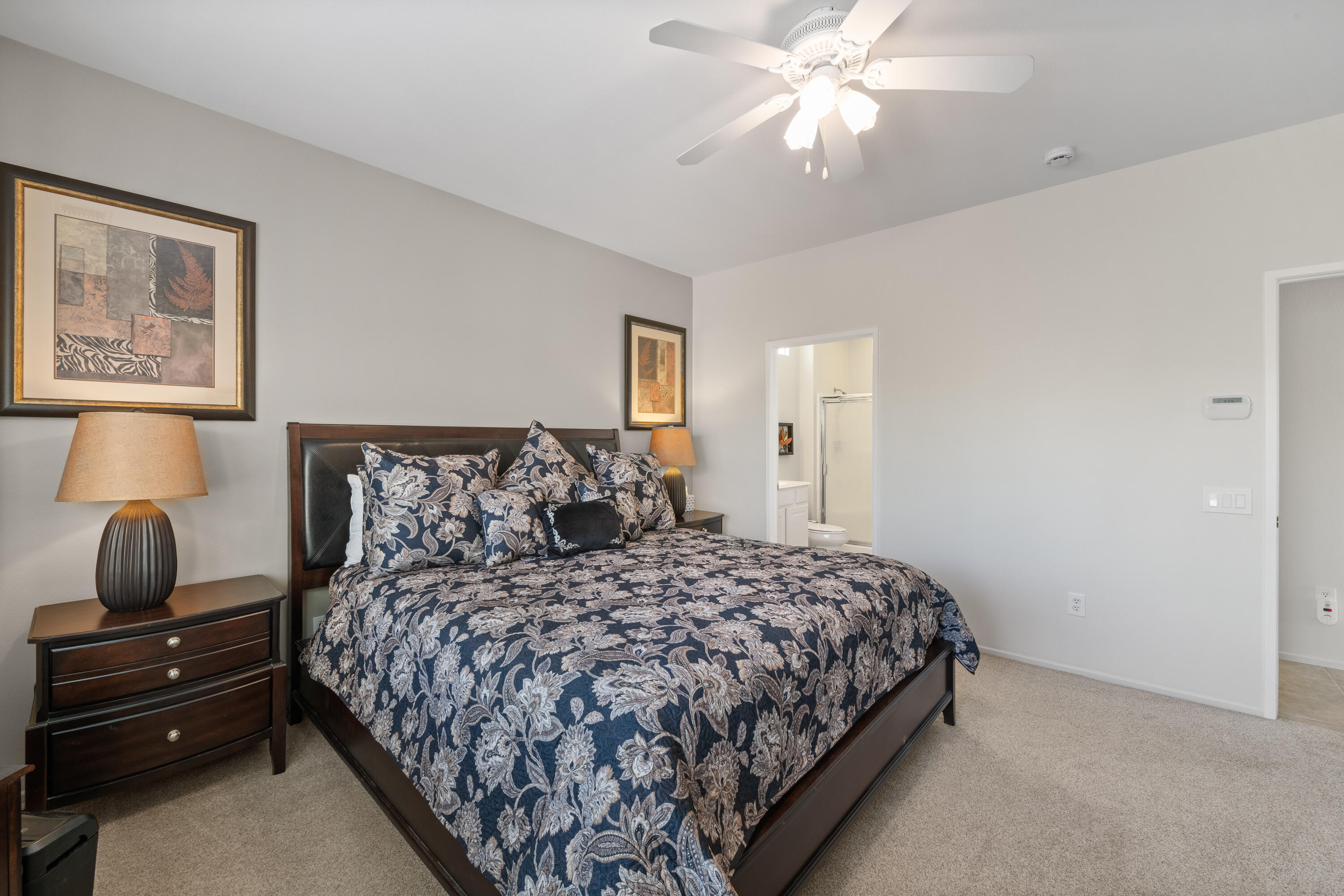 78680 Postbridge Circle Palm Desert, CA 92211 - Photo 16 of 54 a bedroom with a bed and ceiling fan