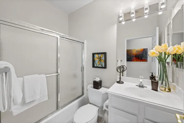 a view of a porch with furniture and a yard