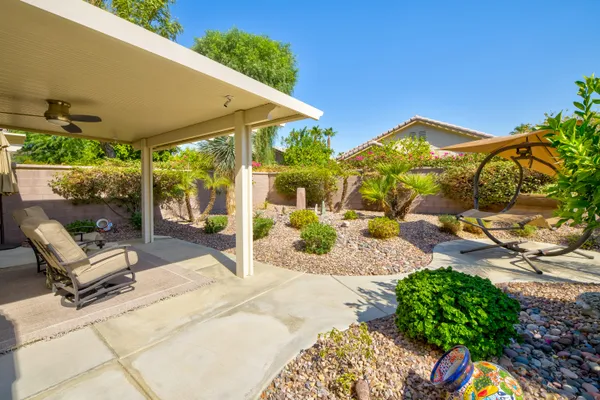 a view of a house with backyard porch and sitting area