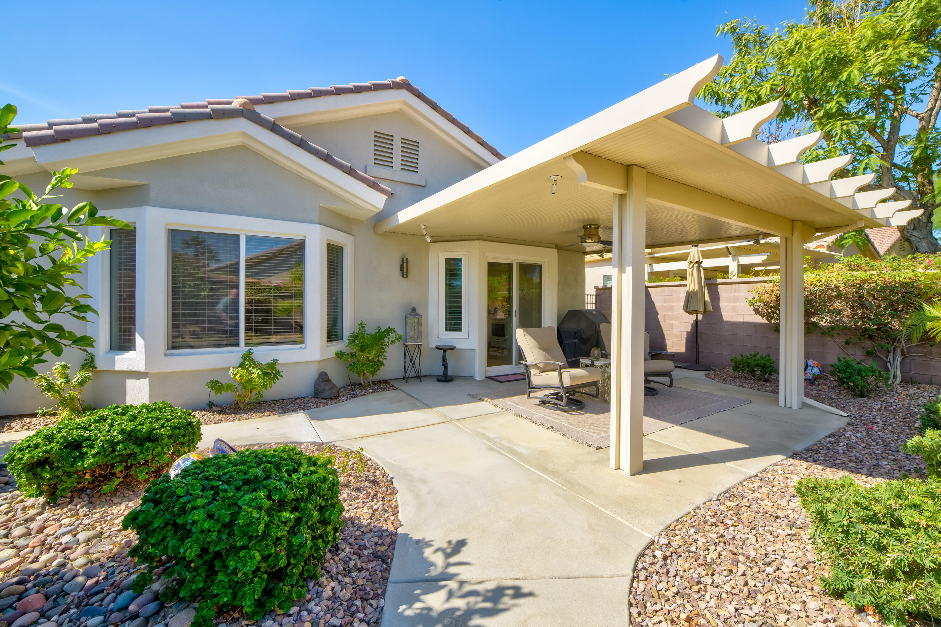 78680 Postbridge Circle Palm Desert, CA 92211 - Photo 26 of 54 a view of a house with backyard porch and sitting area