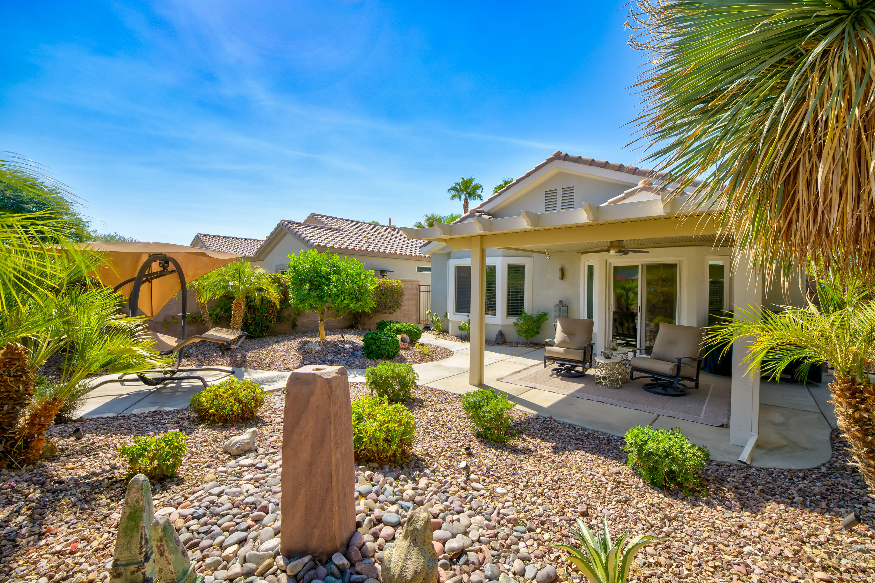 78680 Postbridge Circle Palm Desert, CA 92211 - Photo 27 of 54 a front view of a house with garden