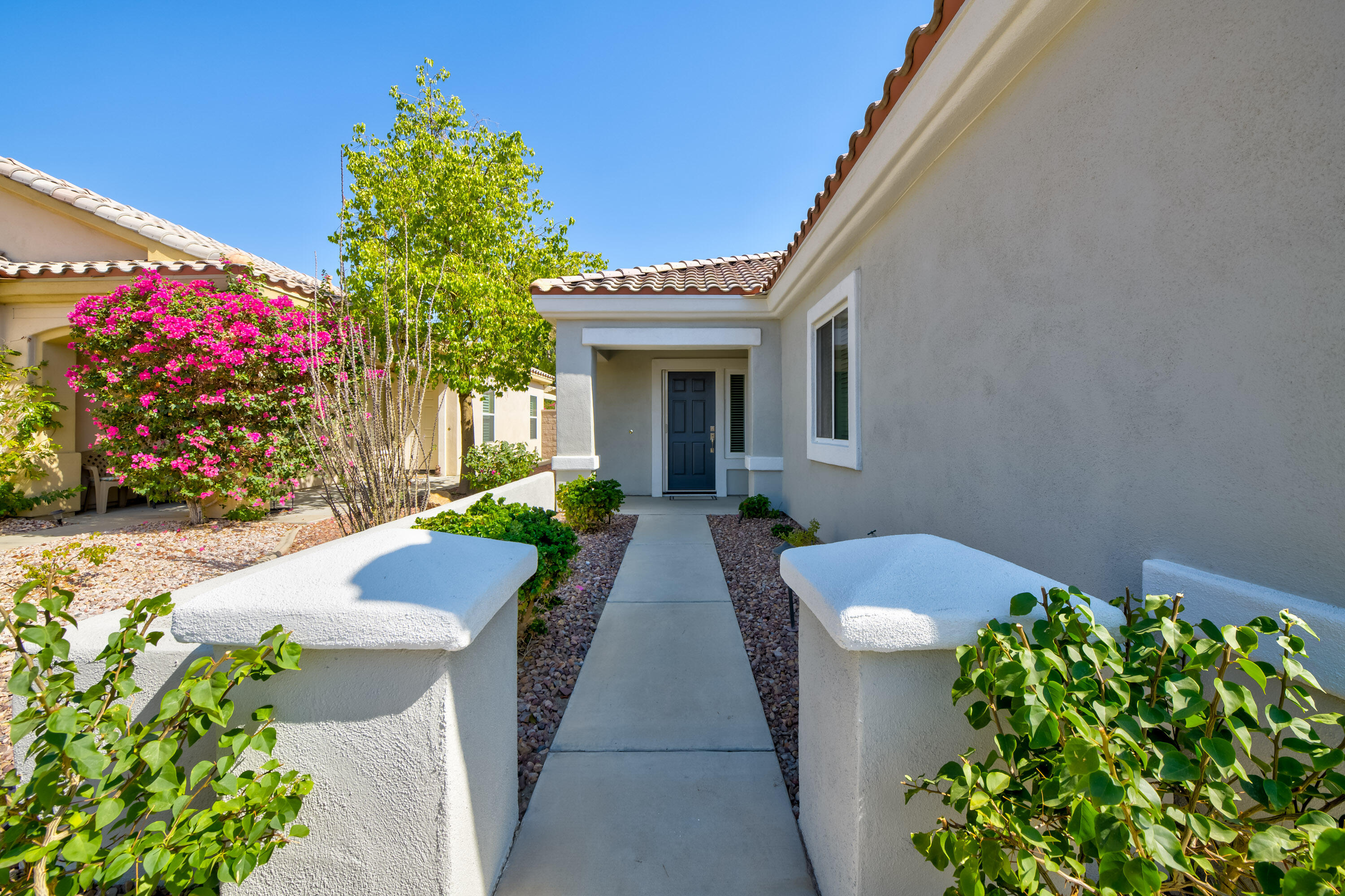 78680 Postbridge Circle Palm Desert, CA 92211 - Photo 31 of 54 a front view of a house with a yard