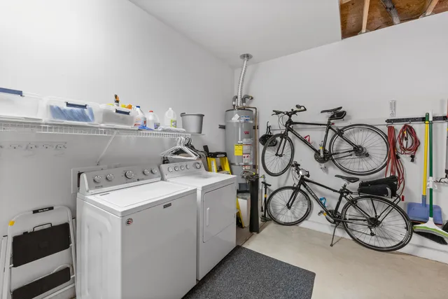 a kitchen with stainless steel appliances granite countertop white cabinets a sink a stove a refrigerator and white cabinets