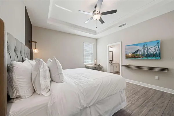 a bedroom with a bed and a chandelier