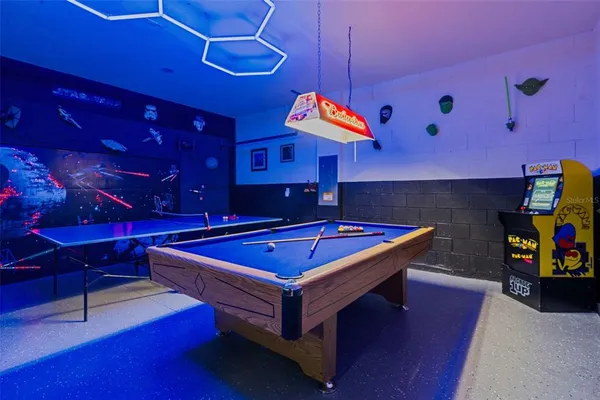 a room with pool table and a chandelier