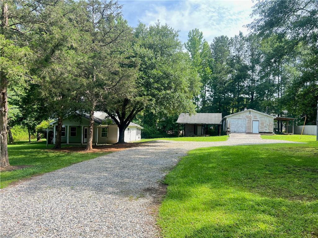 340 Womack Avenue Dallas, GA 30157 - Photo 1 of 29 a front view of a house with a yard and trees
