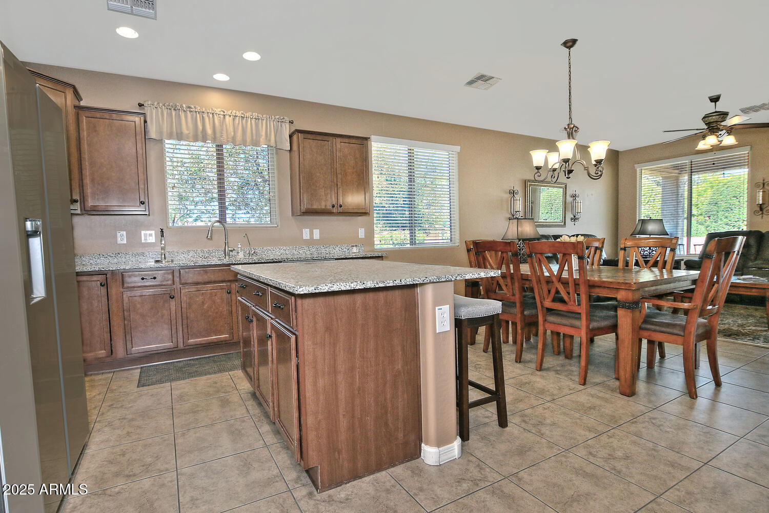 7382 West Silver Spring Way Florence, AZ 85132 - Photo 11 of 89 a dining hall with a dining table chairs and large windows