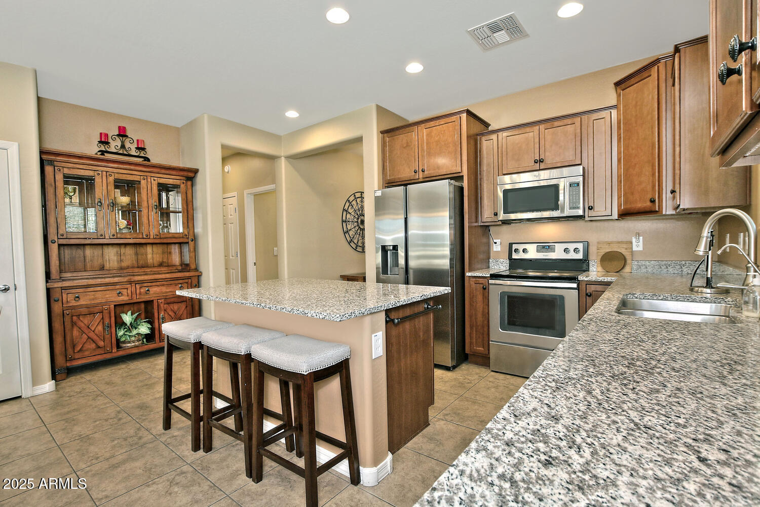 7382 West Silver Spring Way Florence, AZ 85132 - Photo 13 of 89 a kitchen with granite countertop a refrigerator stove top oven and sink