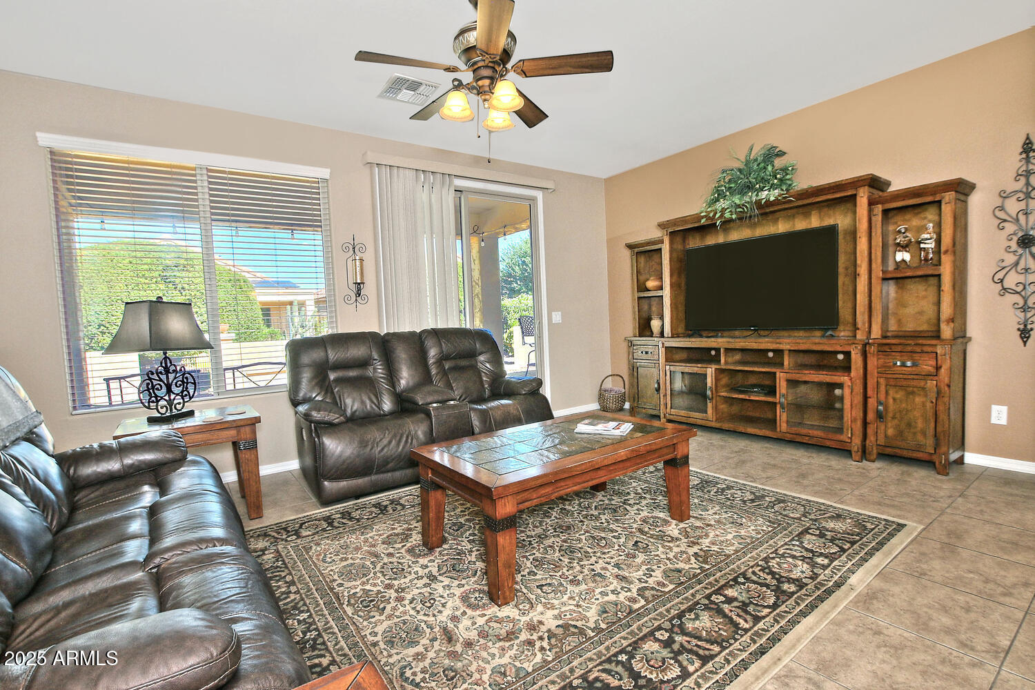 7382 West Silver Spring Way Florence, AZ 85132 - Photo 16 of 89 a living room with furniture and a flat screen tv