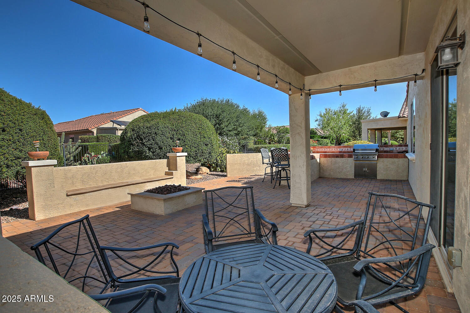 7382 West Silver Spring Way Florence, AZ 85132 - Photo 19 of 89 a view of a patio with a dining table and chairs with two barbeque