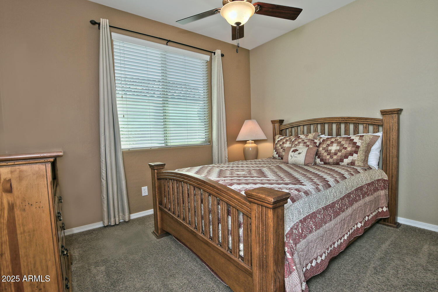 7382 West Silver Spring Way Florence, AZ 85132 - Photo 32 of 89 a bedroom with a bed and a chandelier