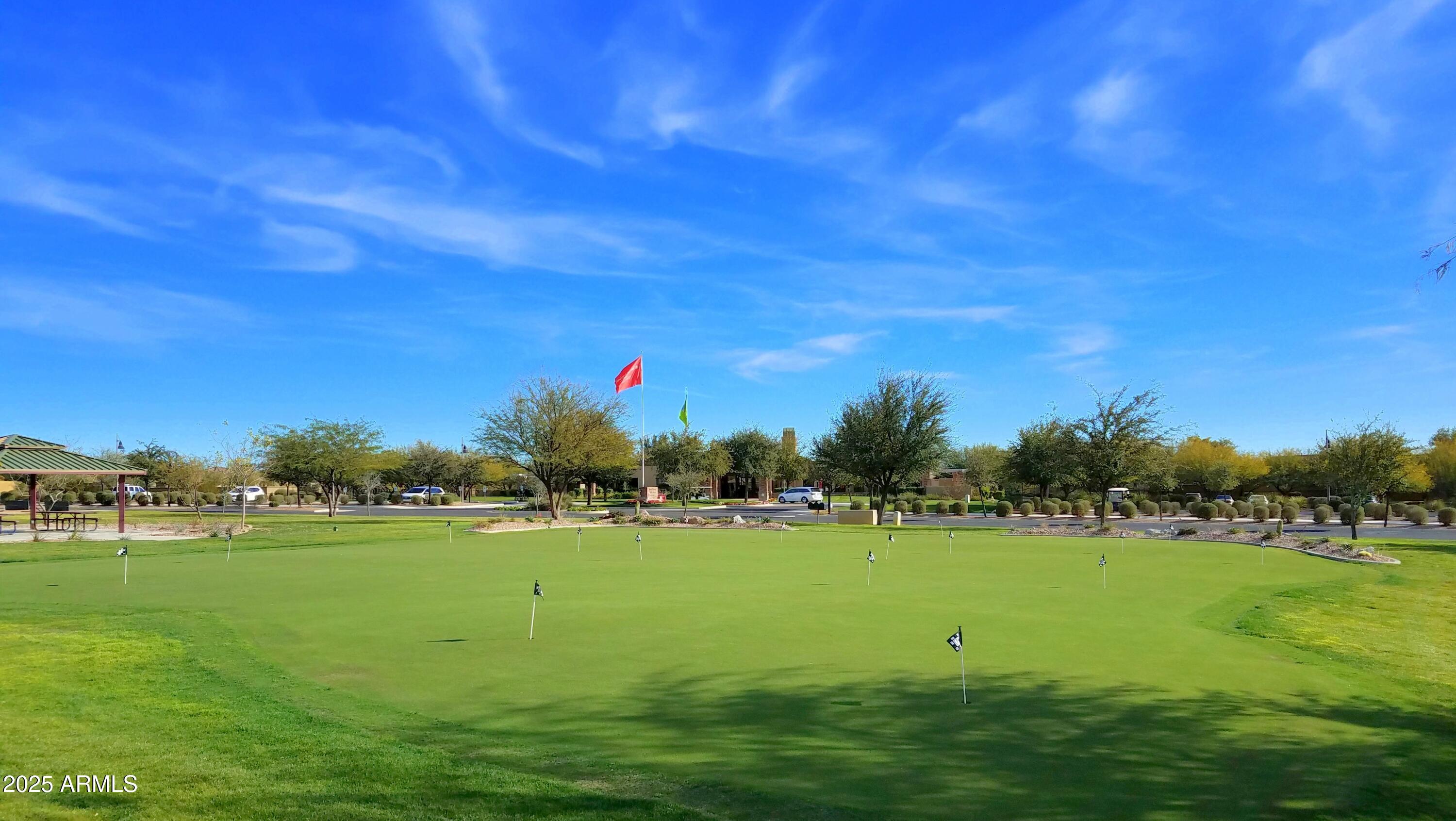 7382 West Silver Spring Way Florence, AZ 85132 - Photo 64 of 89 a view of a golf course with a lake