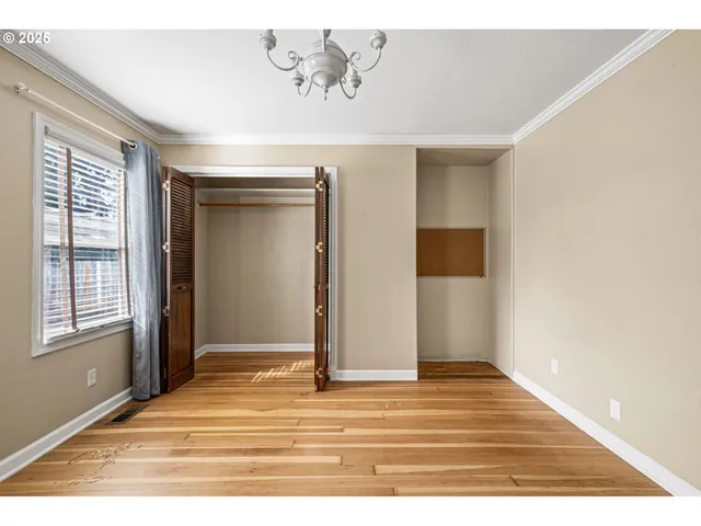 a view of a livingroom with wooden floor and a window