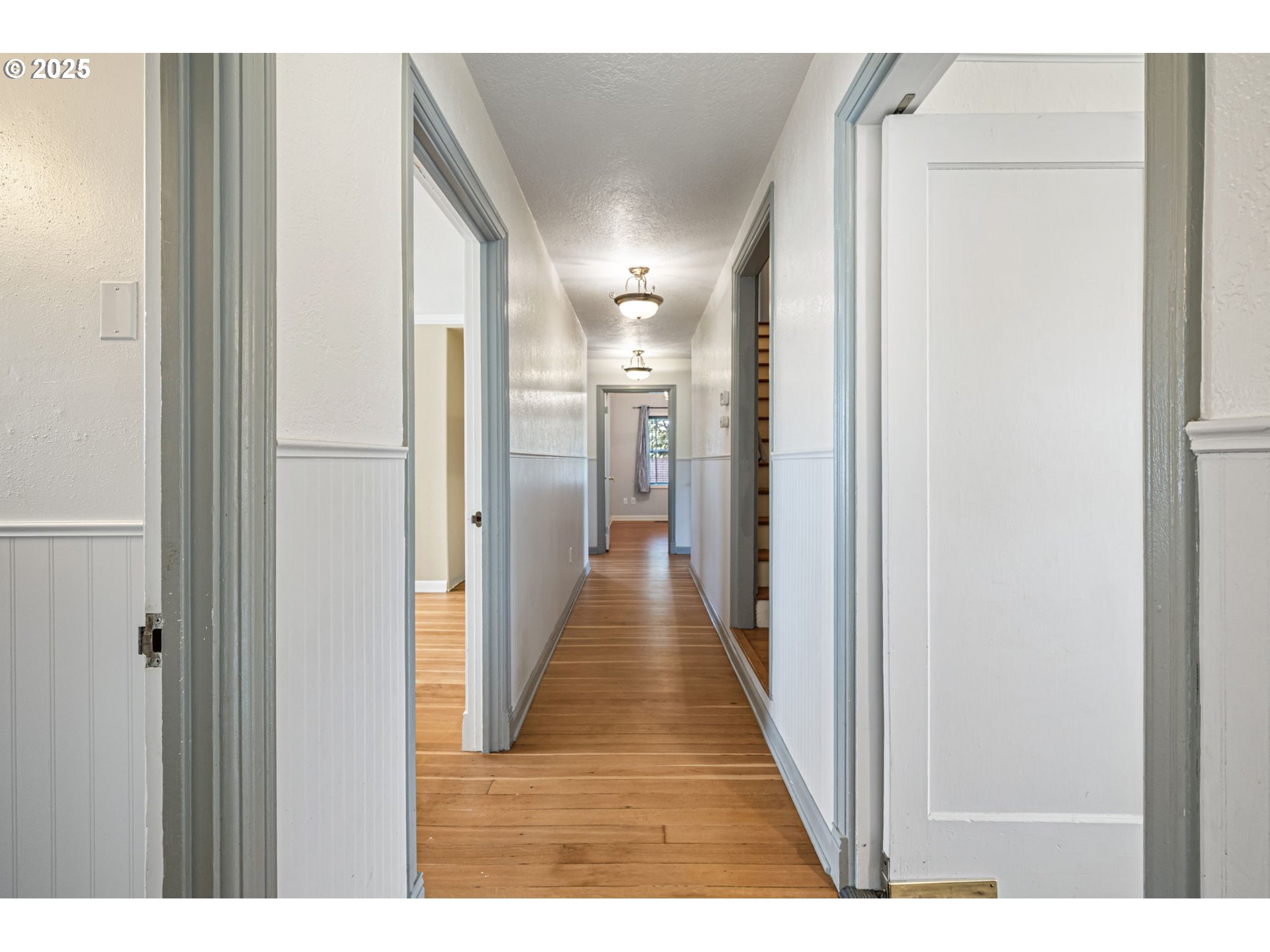1115 South 6th Street Cottage Grove, OR 97424 - Photo 26 of 38 a view of a hallway with wooden floor