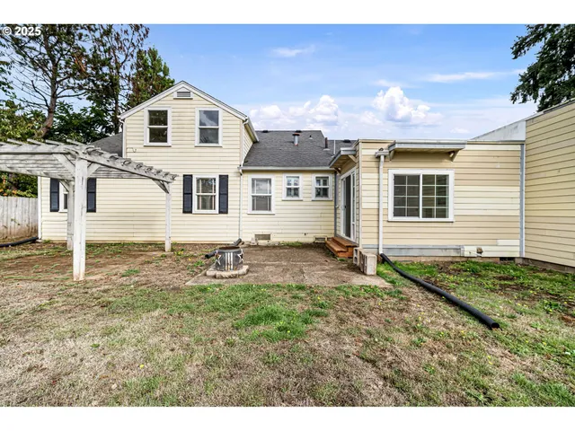 a white house with a yard and plants