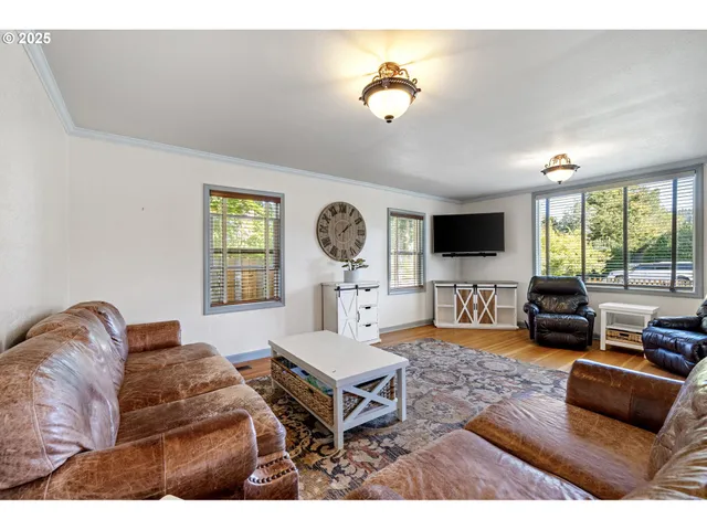 a living room with furniture window and flat screen tv