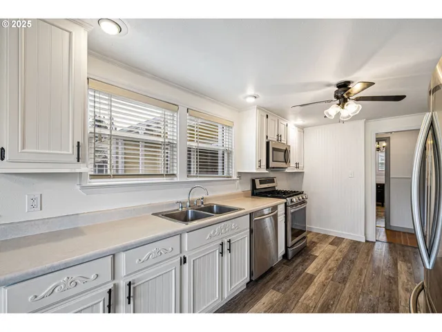 a kitchen with a sink stove and refrigerator