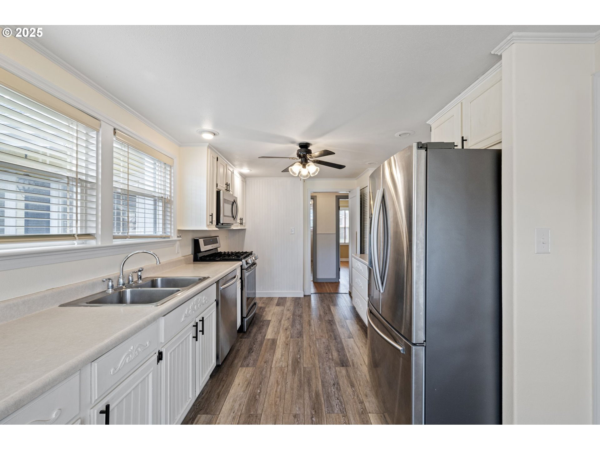 1115 South 6th Street Cottage Grove, OR 97424 - Photo 9 of 38 a kitchen with kitchen island a sink stainless steel appliances and cabinets