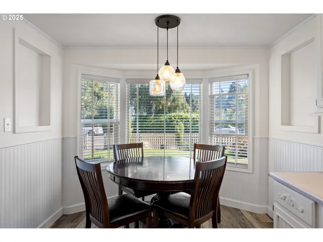 a view of a dining room with furniture wooden floor and chandelier